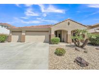 Charming home featuring a spacious three-car garage and low-maintenance desert landscaping at 209 N 237Th Ave, Buckeye, AZ 85396