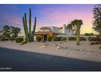 Elegant home with desert landscaping, a fountain, and lush greenery create a welcoming curb appeal at 5345 E Mclellan Rd # 123, Mesa, AZ 85205