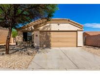 Inviting single-story home featuring a well-maintained yard and attached two-car garage at 5675 S 239Th Ln, Buckeye, AZ 85326