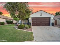 Charming single-Gathering home with mature trees, a well-manicured lawn, and a two-car garage at 5711 E Gable Ave, Mesa, AZ 85206