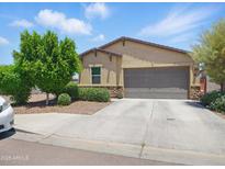 Charming single-story home with a well-manicured lawn, two-car garage, and inviting curb appeal at 10236 W Wood St, Tolleson, AZ 85353