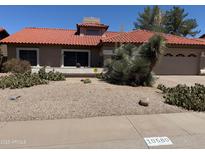 Charming single-story home featuring a desert landscaped front yard and a terracotta tile roof at 10580 E San Salvador Dr, Scottsdale, AZ 85258