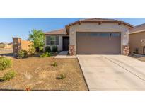 Charming single-story home featuring a low-maintenance yard, inviting curb appeal, and an attached two-car garage at 12505 W Kaler Dr, Glendale, AZ 85307