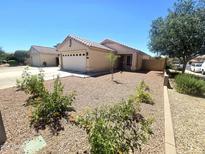 Charming single-story home featuring a well-maintained desert landscape and inviting curb appeal at 13037 W Laurel Ln, El Mirage, AZ 85335