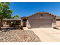 Charming single-story home features low-maintenance landscaping and attached two car garage at 1376 E Rosemary Trl, Casa Grande, AZ 85122