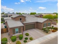 Stunning single-Gathering home featuring a three-car garage, meticulous landscaping and desert style plants at 14075 W Desert Flower Dr, Goodyear, AZ 85395