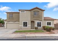 Charming two-story home featuring desert landscaping, neutral stucco, and a tile roof at 1410 S Boulder St # A, Gilbert, AZ 85296