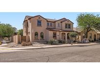 Two-story home featuring neutral colored stucco exterior, arched windows and terracotta roof tiles at 1710 S Parkcrest St, Gilbert, AZ 85295