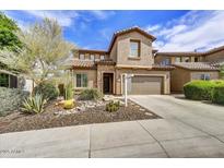 Two-story home featuring a well-maintained xeriscaped front yard and a private two-car garage at 1854 W Fetlock Trl, Phoenix, AZ 85085