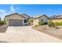 A lovely single-Gathering home featuring a well-manicured yard and a spacious two-car garage at 20082 N 272Nd Ln, Buckeye, AZ 85396