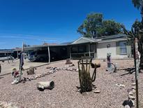 Landscaped front yard with rock, desert plants and covered parking at 2011 N 26Th Cir, Mesa, AZ 85213