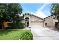 Charming single-story home with well-manicured lawn, mature landscaping, and inviting two-car garage at 2727 S 160 Ln, Goodyear, AZ 85338