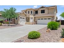 Inviting two-story home features manicured landscaping, multi-car garage, and a neutral color palette at 31221 N 130Th Ln, Peoria, AZ 85383
