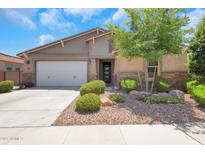 Charming single-story home featuring well-kept landscaping and a two-car garage, enhancing its curb appeal at 4853 N 183Rd Ln, Goodyear, AZ 85395