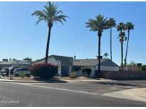 Charming single-story home with mature palm trees and a well-maintained yard at 5143 W Mountain View Rd, Glendale, AZ 85302