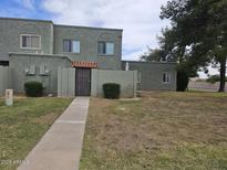 Inviting condo with drought-tolerant landscaping, private entrance, and attractive facade at 5446 W Sheena Dr, Glendale, AZ 85306