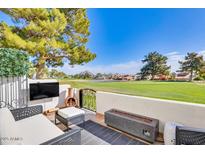 Relaxing outdoor patio with comfortable seating, fireplace, and scenic golf course views at 6131 N 28Th Pl, Phoenix, AZ 85016