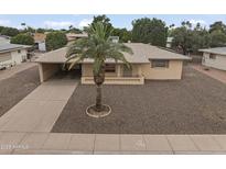 View of single-story home showcasing the well-maintained landscape, neutral tones, and convenient carport at 6217 E Dodge St, Mesa, AZ 85205