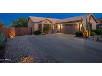 Charming single-story home with desert landscaping, a paved driveway, and a two-car garage. Ideal for suburban living at 6939 S Red Hills Rd, Gold Canyon, AZ 85118