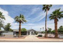 Charming single-story home with desert landscaping, concrete driveway, and mature palm trees at 7201 N 16Th Dr, Phoenix, AZ 85021