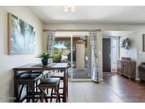 Bright dining area features a sliding glass door leading to an outdoor area, allowing for natural light to fill the space at 811 E Eugie Ave, Phoenix, AZ 85022