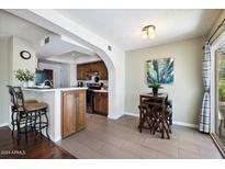 Cozy dining area with counter seating and adjacent kitchen, great for casual meals and entertaining guests at 811 E Eugie Ave, Phoenix, AZ 85022