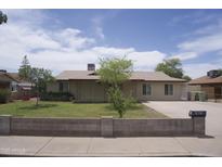 Traditional home with desert landscaping, long driveway, and block wall for added curb appeal at 8334 N 55Th Ave, Glendale, AZ 85302