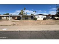 Charming single-story home with a carport and palm trees in a residential neighborhood at 9251 N 36Th Dr, Phoenix, AZ 85051
