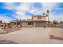 Inviting two-story home featuring a two-car garage and drought-tolerant landscaping at 9803 N 40Th Dr, Phoenix, AZ 85051