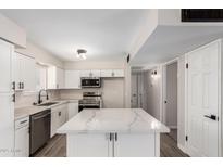 Spacious kitchen features quartz countertops, white cabinets, and stainless steel appliances at 143 W Ray Rd, Chandler, AZ 85225
