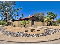 Charming single-story home with desert landscaping, palm trees, and a beautiful walkway at 15226 N 51St St, Scottsdale, AZ 85254