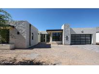 Modern home with stone accents, a glass garage door, and a contemporary design at 1538 W Wagon Wheel Dr, Phoenix, AZ 85021