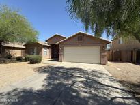 Charming single-story home featuring a large two car garage and desert landscaping, complemented by blue sky at 1930 W Burgess Ln, Phoenix, AZ 85041