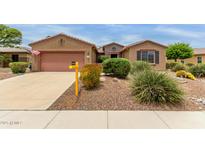 Charming single-story home with desert landscaping, a two-car garage and a 'Coming Soon' sign in the front yard at 19722 N Regents Park Dr, Surprise, AZ 85387