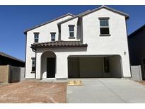 Charming two-story home with a stucco exterior, an attached two-car garage, and a brown tiled roof at 29789 N Oak Dr, Florence, AZ 85132