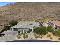 Stunning desert home with beautiful stonework, mature landscaping, and a charming paver driveway at 36133 N 24Th Ave, Phoenix, AZ 85086