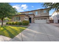 Charming two-story home with a three-car garage, manicured lawn, and vibrant landscaping at 3822 E Amber Ln, Gilbert, AZ 85296