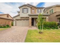 Charming two-story home with a well-manicured lawn, stone accents, and a two-car garage at 3938 E Appaloosa Rd, Gilbert, AZ 85296