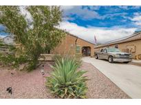 Inviting single-story home featuring desert landscaping and a long driveway at 980 W Prior Ave, Coolidge, AZ 85128