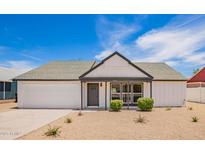 Charming single-story home with a well-manicured yard and appealing modern design at 9855 S 47Th Pl, Phoenix, AZ 85044