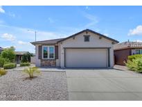 Charming single-story home with a two-car garage, desert landscaping and stone accents at 11159 E Sebring Ave, Mesa, AZ 85212