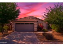 Charming single-story home featuring a two-car garage, desert landscaping, and a beautiful sunset sky at 154 W Hayden Park Rd, San Tan Valley, AZ 85143