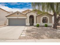 Charming single-story home with a well-maintained front yard, neutral tones, and attached two-car garage at 1707 W Stanford Ave, Gilbert, AZ 85233
