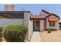 Charming single-story home with a red-tiled roof, desert landscaping, and a covered pergola at 2144 E Center Ln # 3, Tempe, AZ 85281