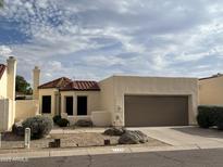 Charming single-story home featuring a tile roof, desert landscaping, and a two-car garage at 2169 E Bishop Dr, Tempe, AZ 85282