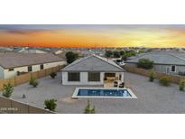 This home has a backyard with a small pool, rock landscaping and a covered patio at 21797 N 259Th Ave, Buckeye, AZ 85396
