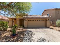 Inviting single-story home featuring a neutral stucco finish, tile roof, desert landscaping, and an attached two-car garage at 2421 W Romley Rd, Phoenix, AZ 85041