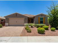 Charming single-story home featuring a desert landscaped front yard, two car garage, and colorful flower bushes at 31324 N 26 Glen Gln, Phoenix, AZ 85085