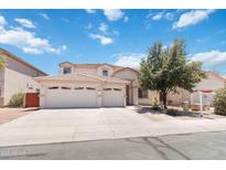 Spacious two-story home with a three car garage and a well-manicured front yard at 43525 W Cydnee Dr, Maricopa, AZ 85138