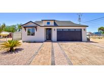 Charming home with a well-maintained yard, attractive landscaping, and a two car garage at 461 W Lindbergh Ave, Coolidge, AZ 85128